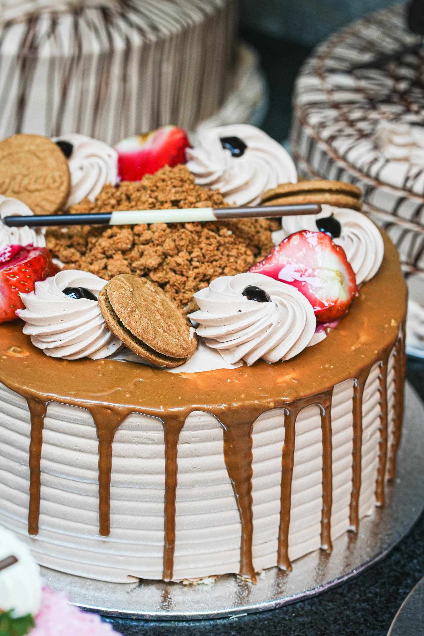 Caramel drip cake with cookies and fresh cream decoration